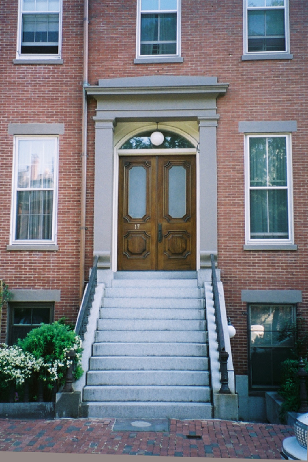 Brick row-house entrance with granite steps