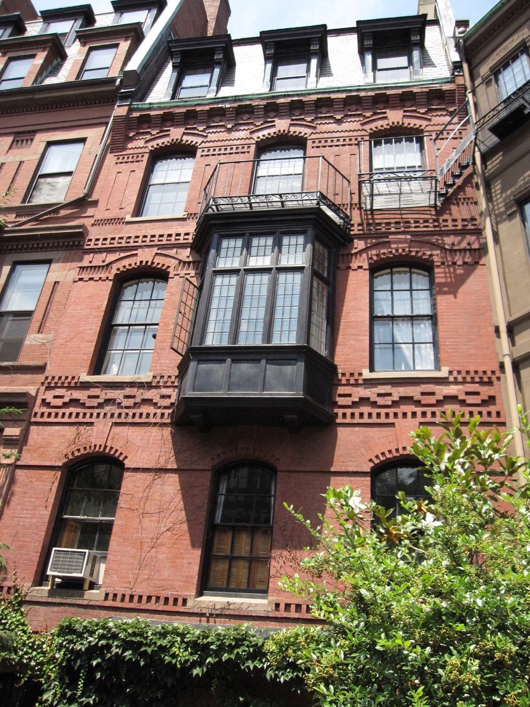 Brick apartment building with a bay window