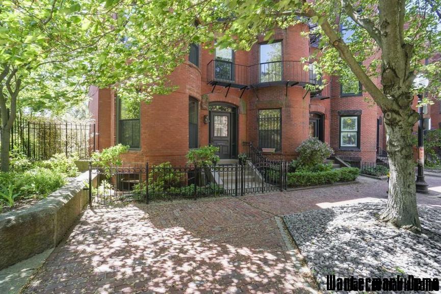 Renovated 4-Story Brownstone in Back Bay - Red-brick brownstone with bay windows behind a wrought-iron railing