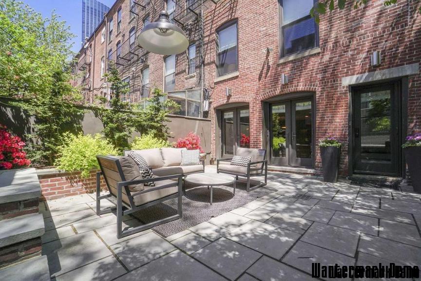 Renovated 4-Story Brownstone in Back Bay - Paved rear courtyard with outdoor seating against exposed brick