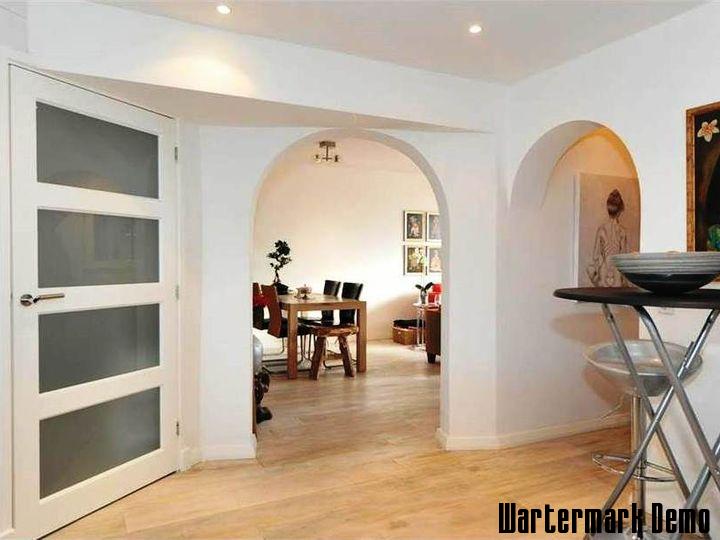 Five-Bedroom Town House on Rue de Rivoli - Hallway with arched openings looking through to the dining room