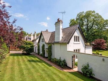 Five-Bedroom Town House on Rue de Rivoli - White-rendered house with a gabled roof and tall chimney, seen across a striped lawn