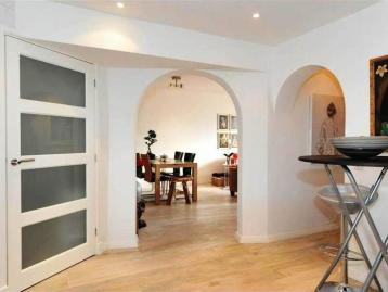 Five-Bedroom Town House on Rue de Rivoli - Hallway with arched openings looking through to the dining room