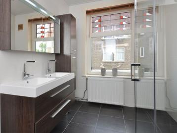 Five-Bedroom Town House on Rue de Rivoli - Bathroom with twin basins on a walnut vanity and a glazed walk-in shower
