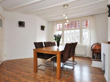 Five-Bedroom Town House on Rue de Rivoli - Dining room with an oak table for six under a beamed ceiling
